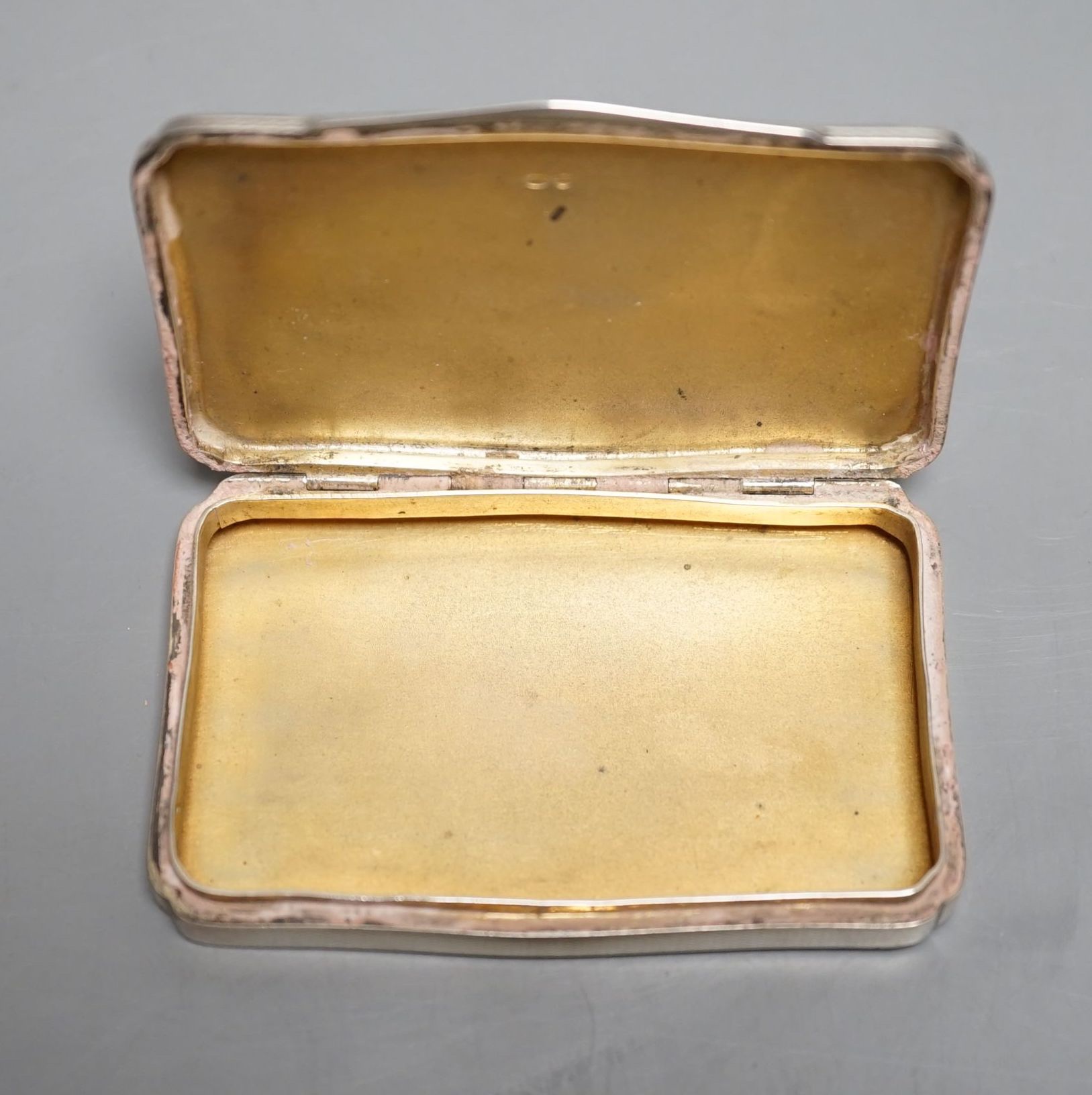 A 1920's continental silver and painted enamel rectangular snuff box, import marks for H.C. Freeman, London, 1929, 81mm, gross 103.7 grams (enamel a.f.).